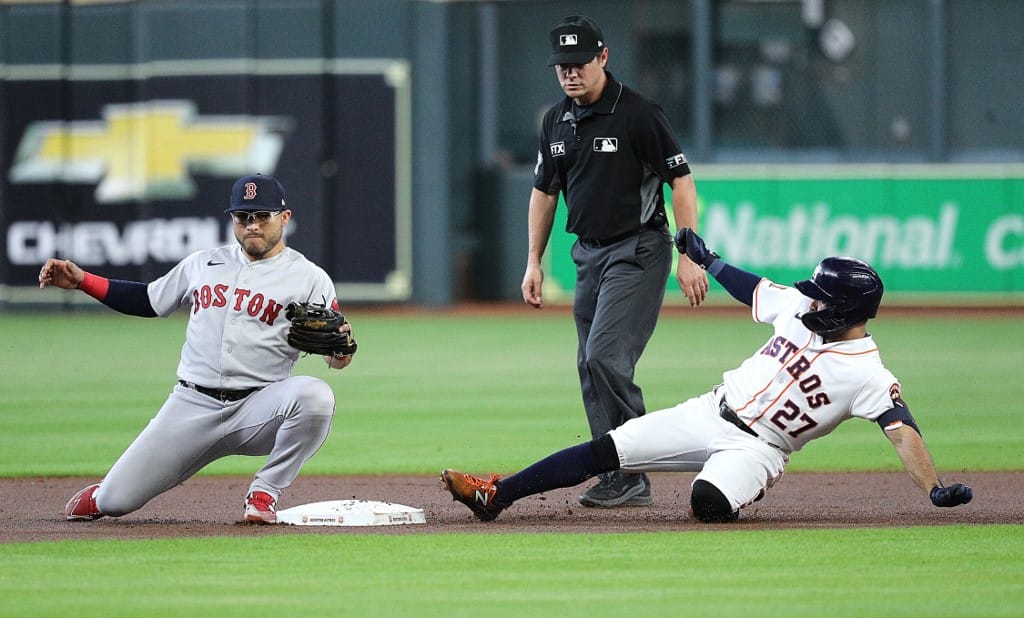 Jose Altuve #27 of the Houston Astros doubles in the first inning as Yolmer Sanchez #47 of the Boston Red Sox can't handle the throw at Minute Maid Park